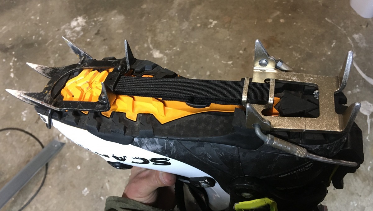 Modified ultralight crampon with nylon webbing replacing the old aluminium linking bar.