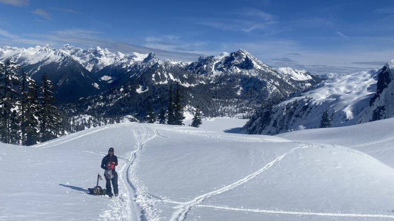 Snacks before the bootback up Roosevelt. Descent from East Shoulder of Chair peak visible on the right amongst the cliffs.