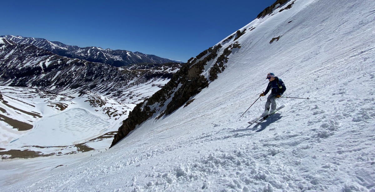 Finding variable but mostly soft snow in the higher stretches of the couloir. Grizzly lake is below.