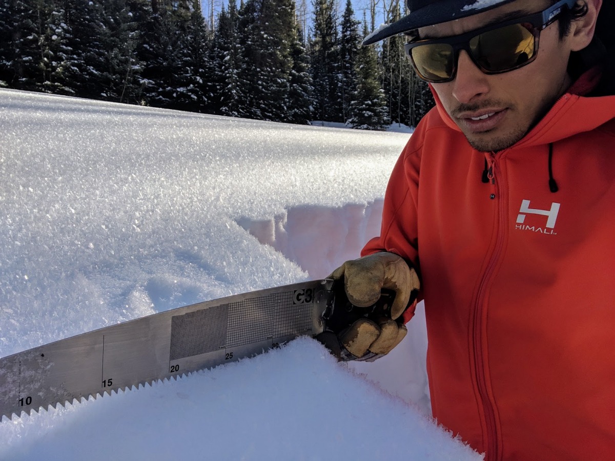 The author investigates a snowpack while skiing in his backyard mountains outside of Vail, CO. The Gore Range, like many other natural features, has a colonial namesake that erases Indigenous history. Recreation in public lands starts with respecting that compex history as you would respect the complexity of a snowpack. In this case, respecting the traditional land of the Núu-agha-t?v?-p?? (Ute) tribe that still exist today. (Photo: Aidan Goldie)