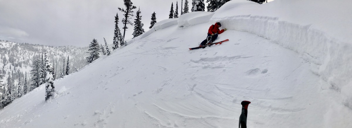Flathead Avalanche Center forecaster Cam Johnson examining the crown of a nasty April Fool's joke. The slide was remotely triggered from the ridge above and ran on a thin layer of recently-buried facets. Flathead Range, MT, April 1, 2020. 