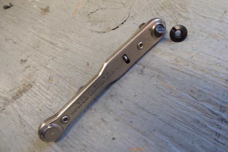 I used a small, right-angle screwdriver to hold the inside screw while I tightened from the outside.