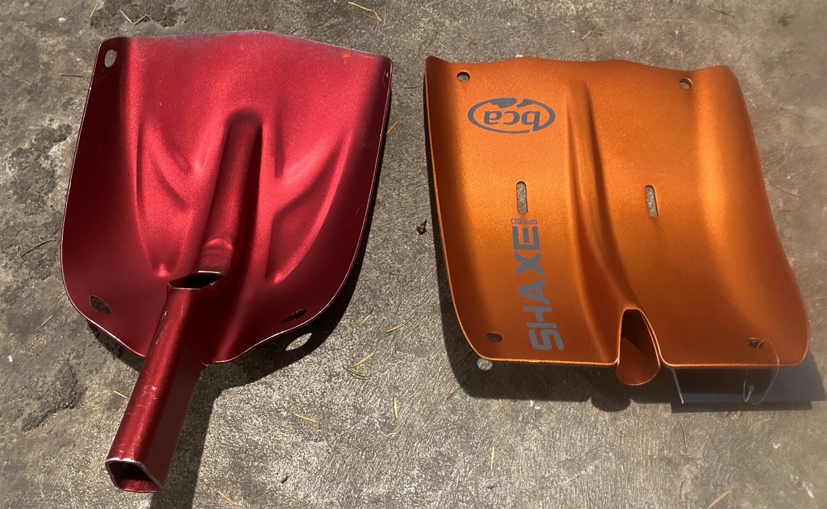 different sizes of shovels, the orange one being slightly larger than the red. In this shot, for contrast, one the orange one is brand new, and the red one is about 5 years old.