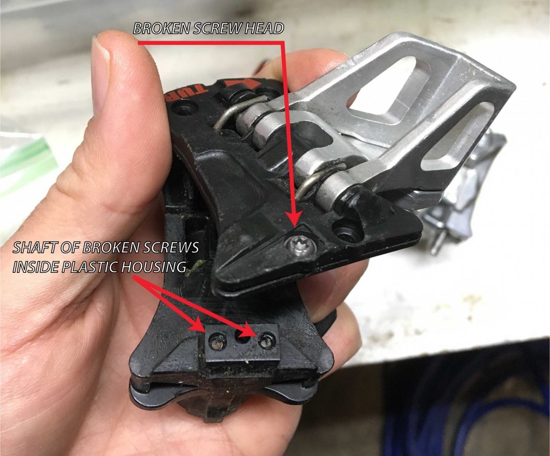 Broken screw visible on a binding. As you can see, the screw snapped (probably due to corrosion or stress), and the ends of the screws are still embedded in the plastic housing. Only the bottom unit (with the embedded screws) needs to be replaced. However, it may be easier to just replace the entire upper heel unit.