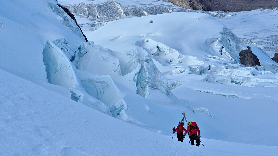 A testament to a lifetime of thoughtful and conservative exploration in the mountains: At age 55, Mike is followed by Steve on route to a first ski descent of 20,000 foot Chumpe in Peru. It was their 20th career ski descent from above 6000meters. Photo: Jim Gile
