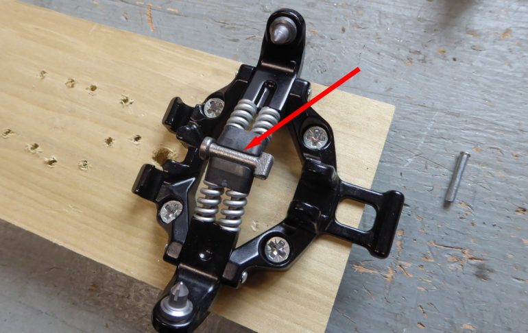 Step 11, carefully position the center stud between the plastic bits and close everything together.
