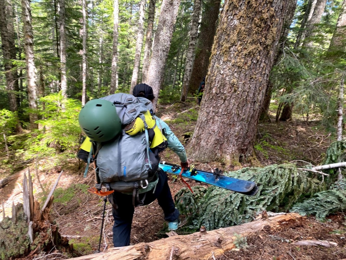 Julia navigating the less steep and cruxy portion of the lower elevation trail, dreaming of reaching the maintained hikers trail.