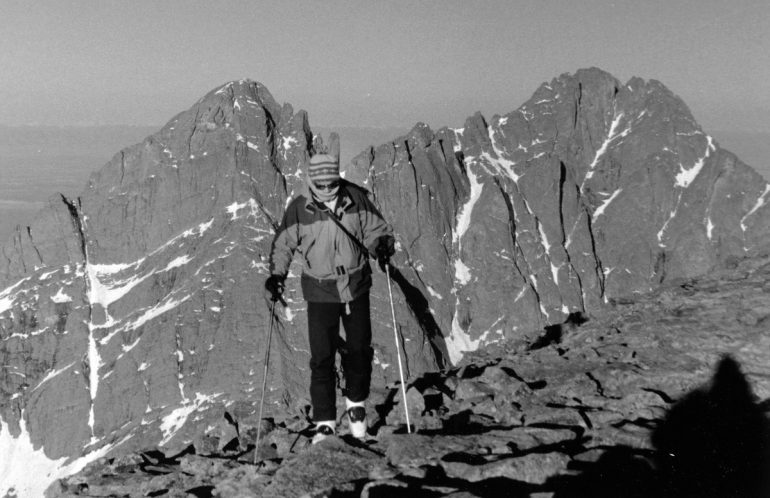 He's got the boots, but where are the planks? On Humboldt Peak looking at Crestone Needle and Peak.