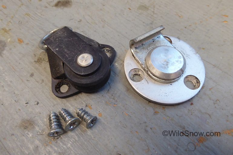 Parts. Front roller to left, central hook and stud to right.