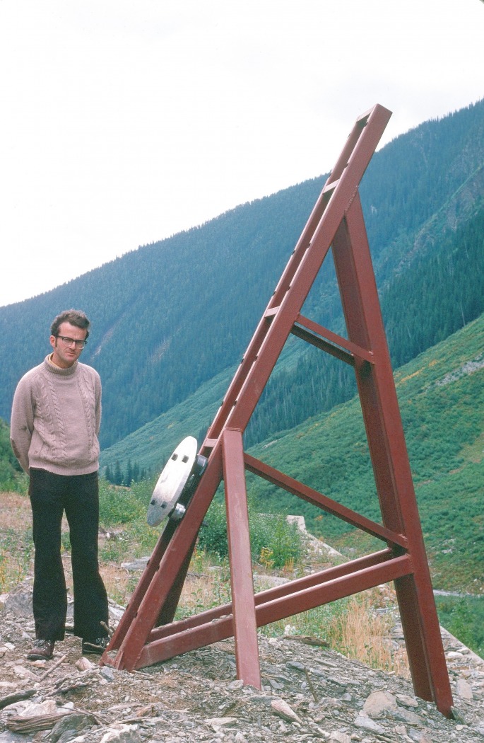 Upslope of a highway shed at Rogers Pass. Terry next to our impact plate mounted on a steel stand installed earlier by Peter Schaerer and Paul Anhorn for their pressure measurements using small pressure cells (Ron Perla photo, 1978.)
