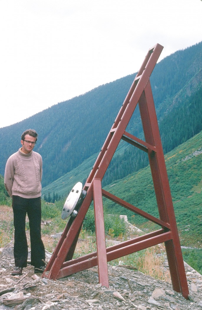 Upslope of a highway shed at Rogers Pass. Terry next to our impact plate mounted on a steel stand installed earlier by Peter Schaerer and Paul Anhorn for their pressure measurements using small pressure cells (Ron Perla photo, 1978.)